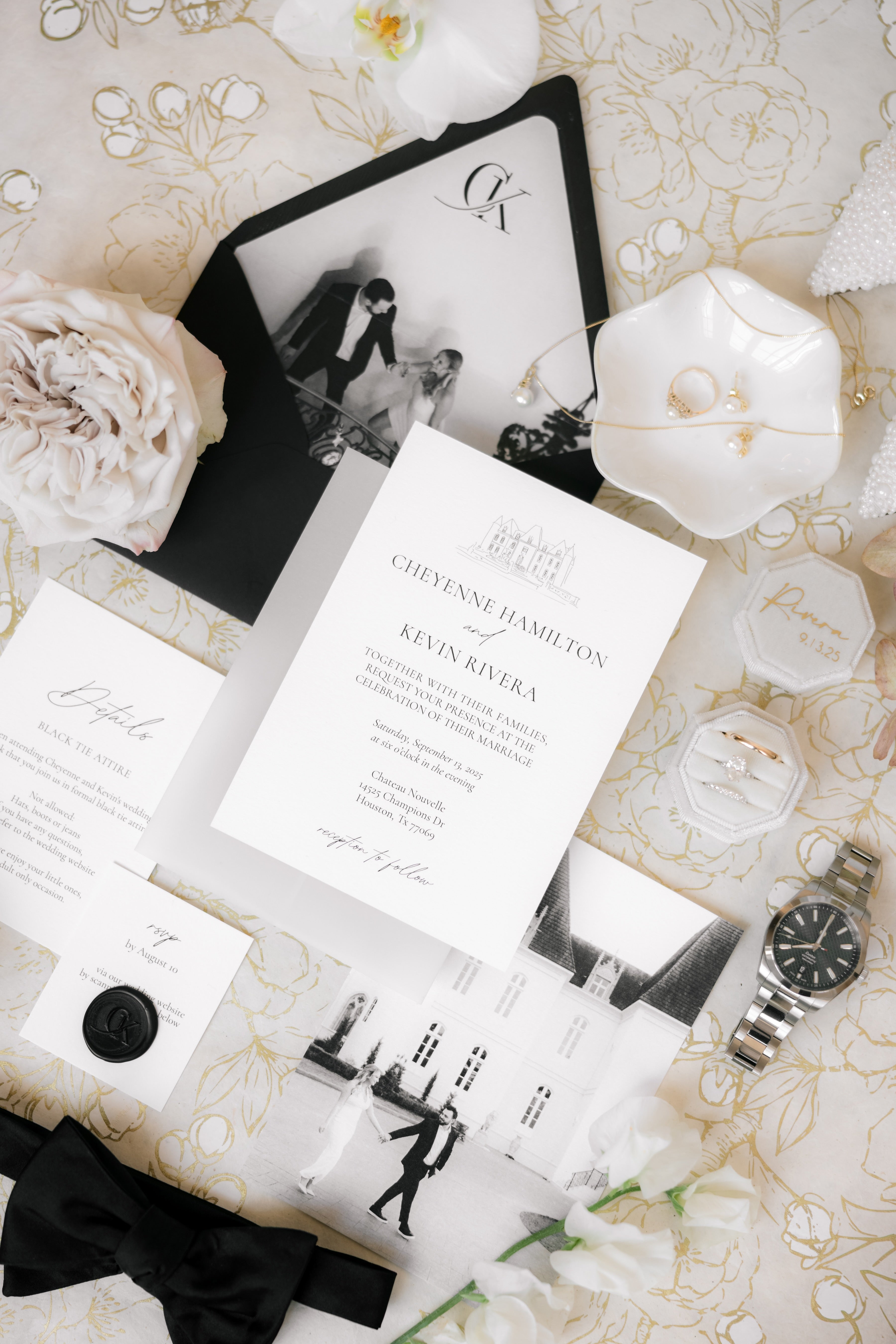 AALVO custom wedding invitations with black and white photos, flowers, and a watch on a decorative surface.
