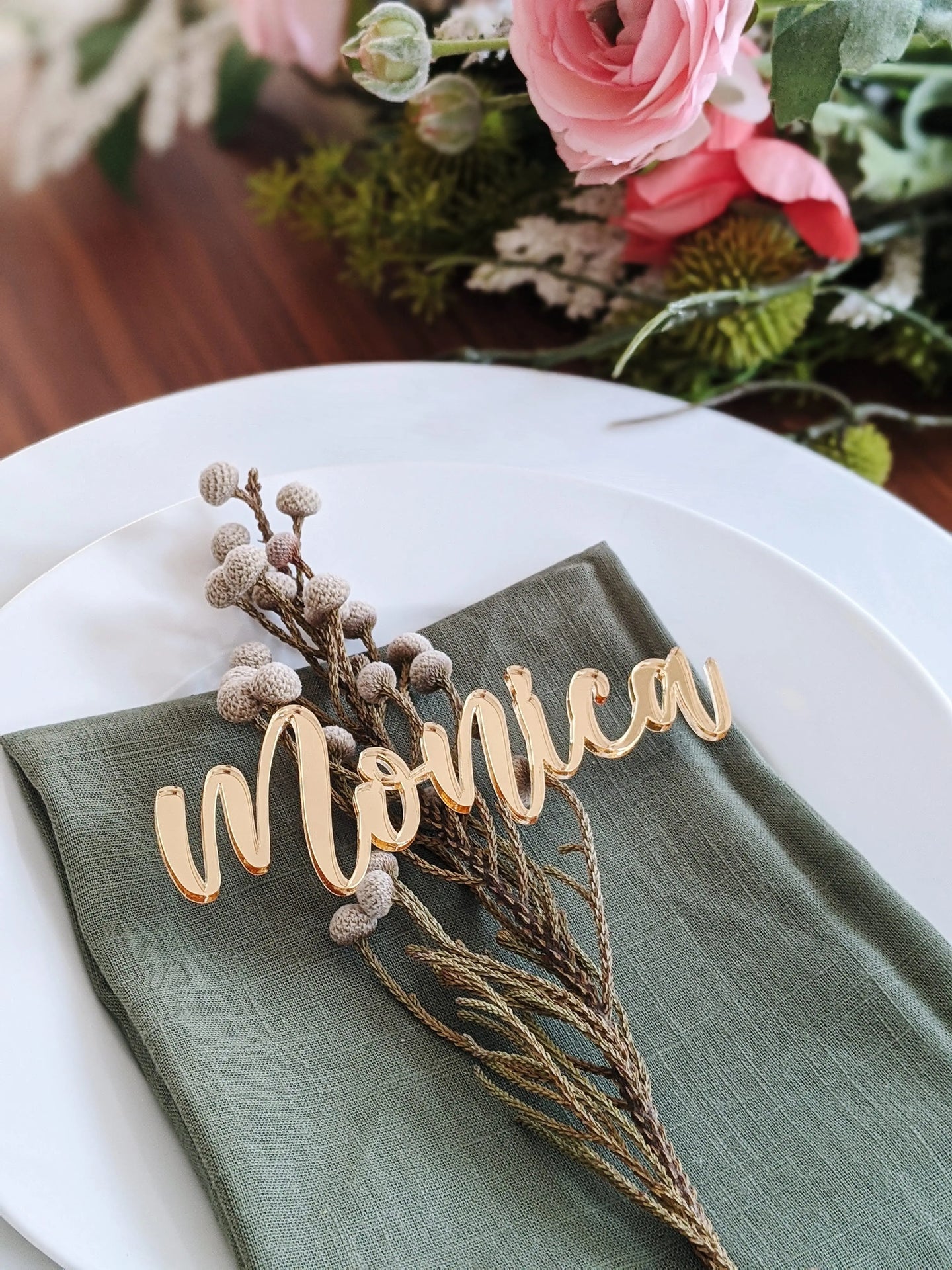 Gold acrylic custom name place card on dinner plate at a wedding party
